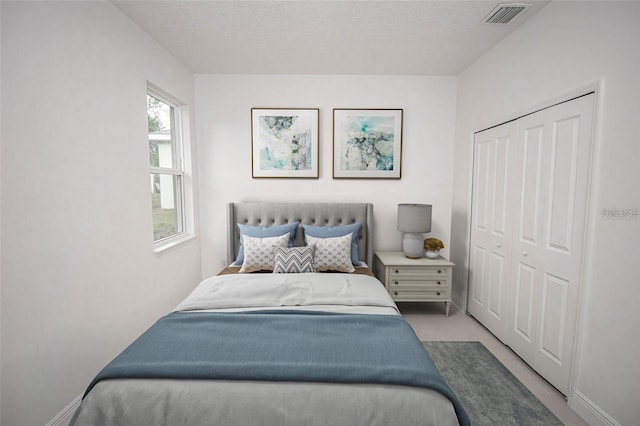 bedroom with a textured ceiling and a closet