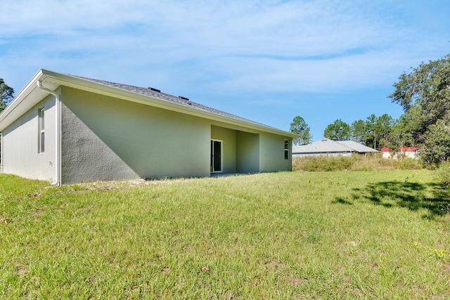 rear view of house with a yard