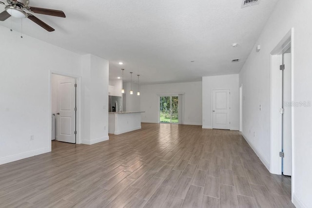 unfurnished living room with light hardwood / wood-style floors and ceiling fan