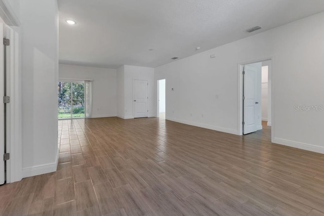 unfurnished room with light hardwood / wood-style floors