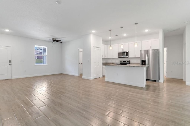 unfurnished living room featuring light hardwood / wood-style flooring and ceiling fan