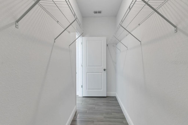 spacious closet featuring hardwood / wood-style flooring