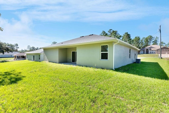 rear view of house with a yard