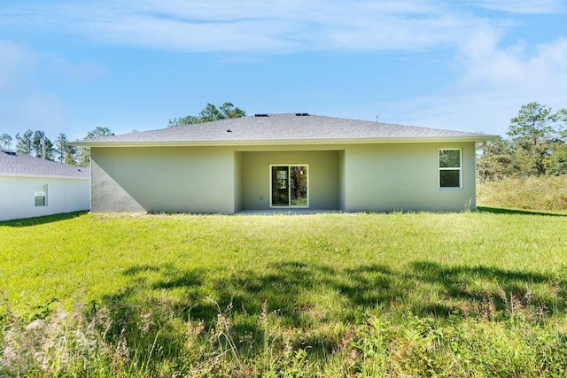 rear view of property with a yard