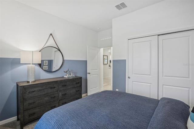 bedroom with a closet and light colored carpet