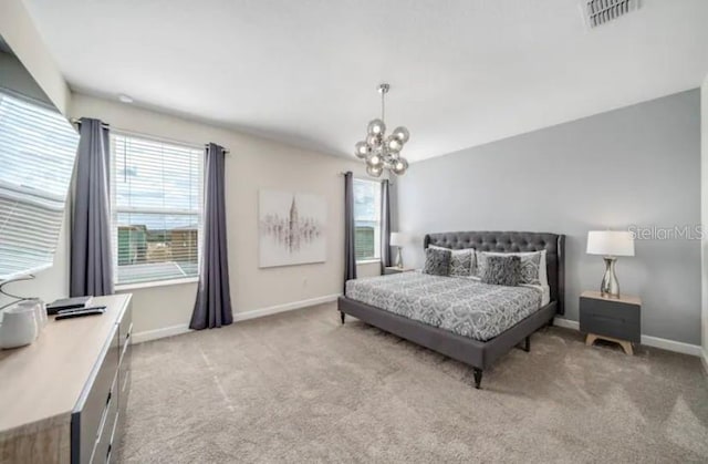 carpeted bedroom featuring an inviting chandelier