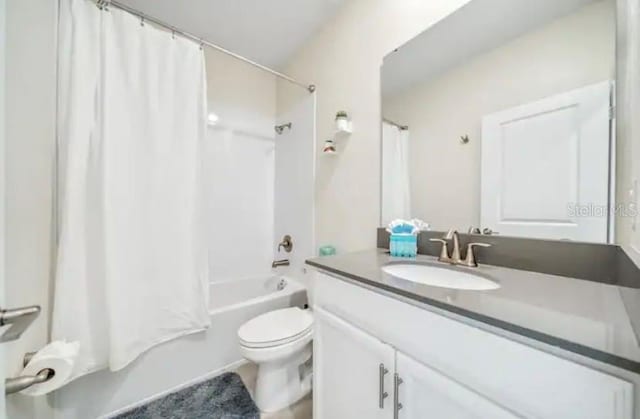 full bathroom featuring shower / bath combination with curtain, vanity, and toilet