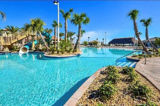 view of pool with a water slide