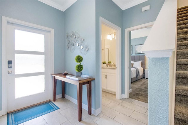 entryway with light tile patterned floors, crown molding, and a wealth of natural light