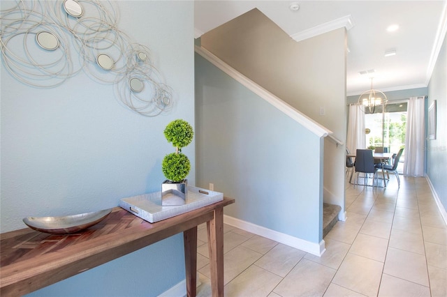 corridor with light tile patterned floors, crown molding, and an inviting chandelier