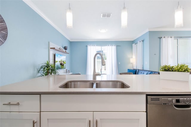 kitchen with pendant lighting, sink, stainless steel dishwasher, and white cabinetry