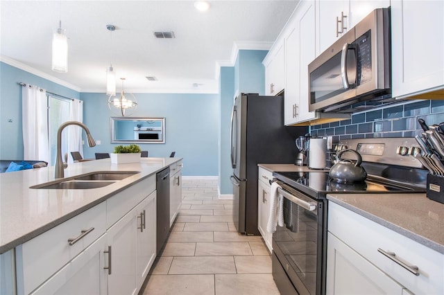 kitchen with stainless steel appliances, sink, crown molding, white cabinetry, and decorative light fixtures