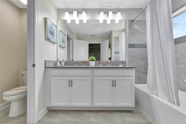 full bathroom with tile patterned flooring, vanity, shower / bath combo with shower curtain, and toilet