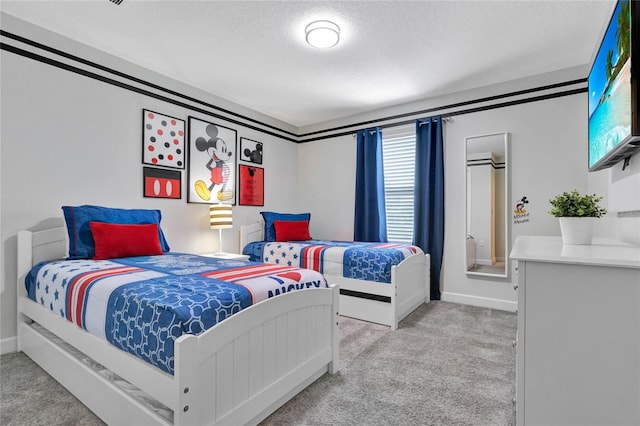 bedroom with light carpet and a textured ceiling