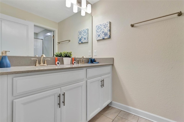 bathroom with vanity, tile patterned flooring, and a shower with door