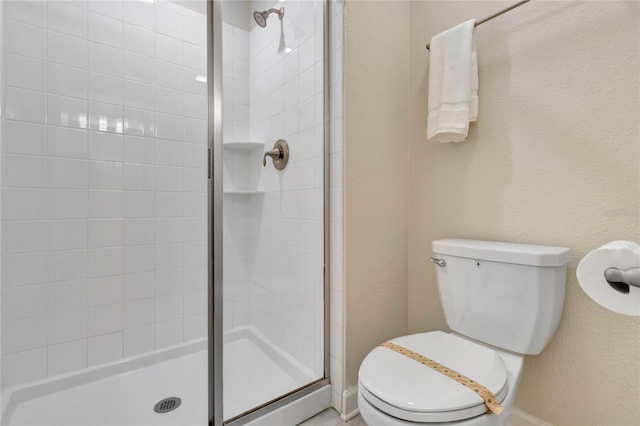 bathroom featuring walk in shower and toilet