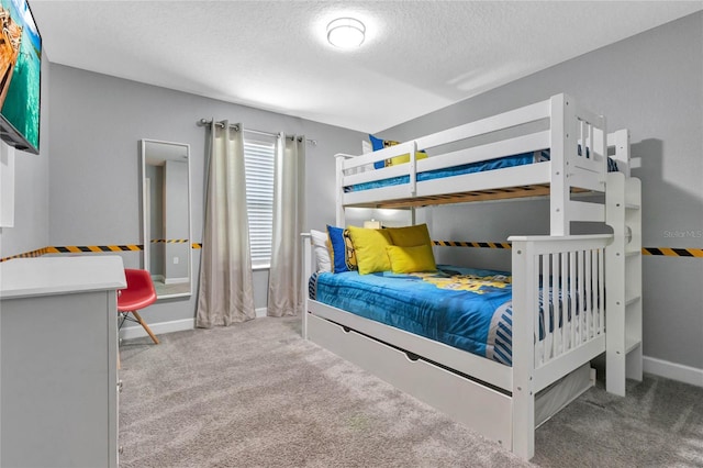 bedroom featuring light colored carpet and a textured ceiling