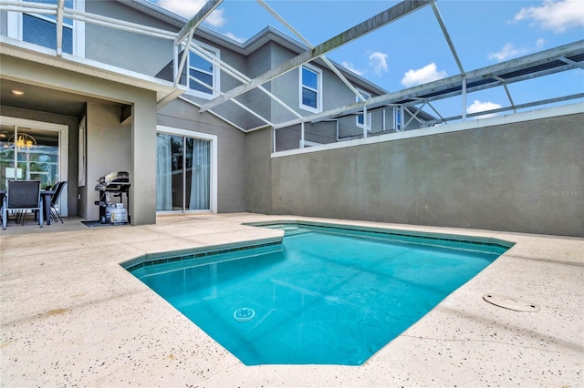 outdoor pool featuring a patio and grilling area