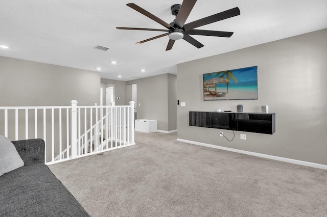 carpeted living room featuring ceiling fan