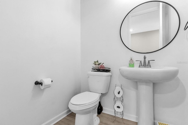 bathroom featuring toilet and hardwood / wood-style flooring