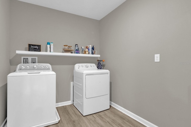 laundry room featuring washer and clothes dryer and hardwood / wood-style flooring