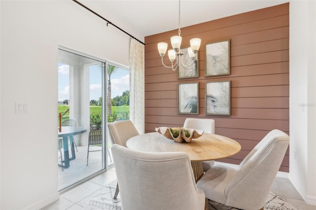 12965 Trovita Dr, Grand Island, FL 32735 - dining area featuring wooden walls, light tile patterned floors, and an inviting chandelier
