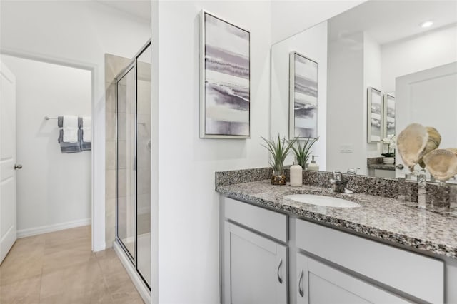 bathroom featuring tile patterned flooring, walk in shower, and vanity