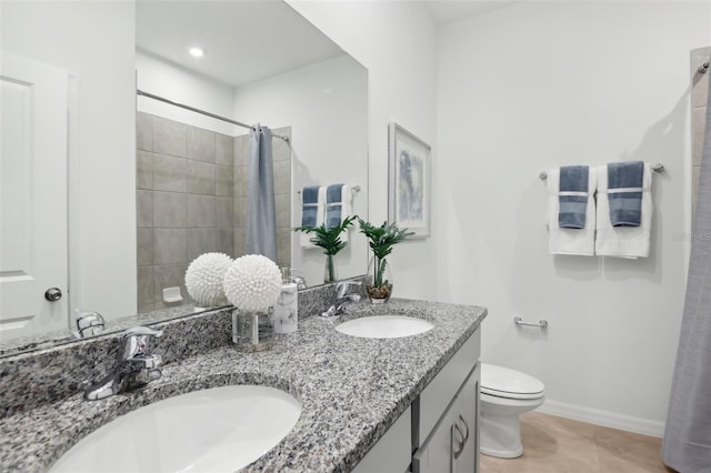 bathroom with vanity, tile patterned flooring, toilet, and curtained shower