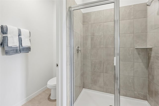 12965 Trovita Dr, Grand Island, FL 32735 - bathroom featuring a shower stall, baseboards, tile patterned flooring, and toilet