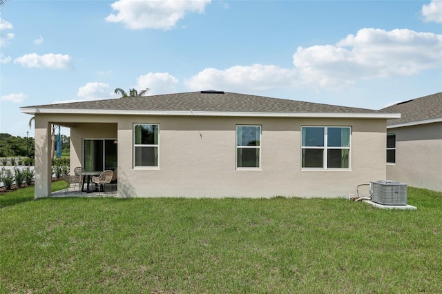 12965 Trovita Dr, Grand Island, FL 32735 - back of house with a yard, a patio, central AC, and stucco siding