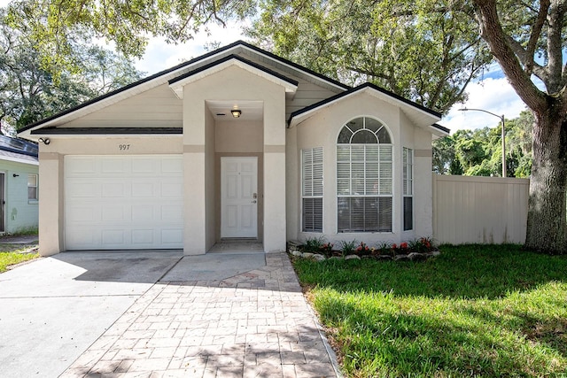 single story home with a front lawn and a garage