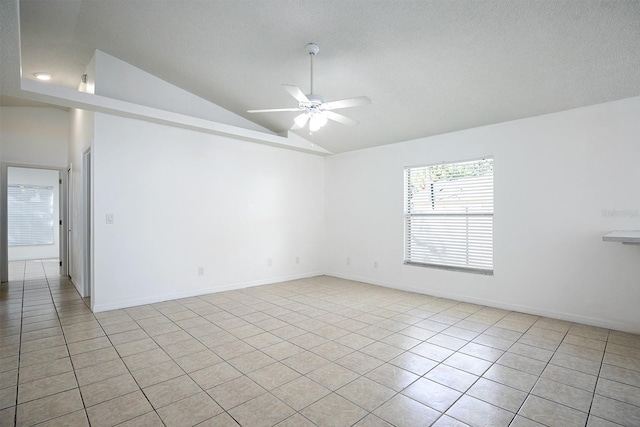 unfurnished room featuring light tile patterned flooring, vaulted ceiling, a textured ceiling, and ceiling fan