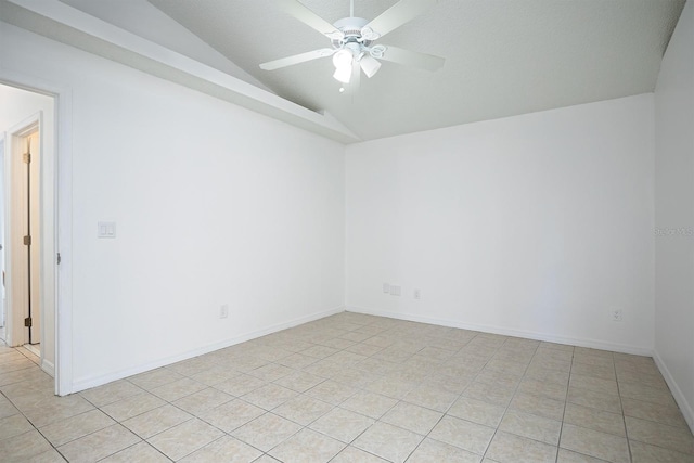 spare room featuring a textured ceiling, vaulted ceiling, light tile patterned floors, and ceiling fan