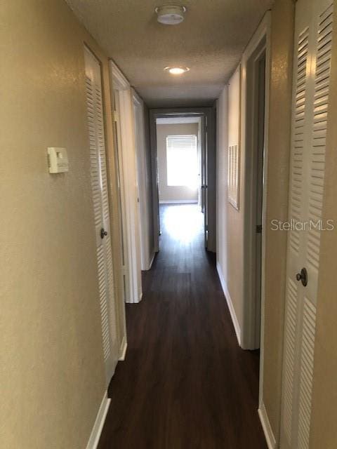 corridor with dark hardwood / wood-style floors