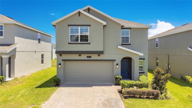 view of front of home with a front lawn and a garage