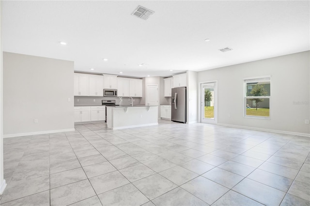 unfurnished living room featuring sink and light tile patterned floors