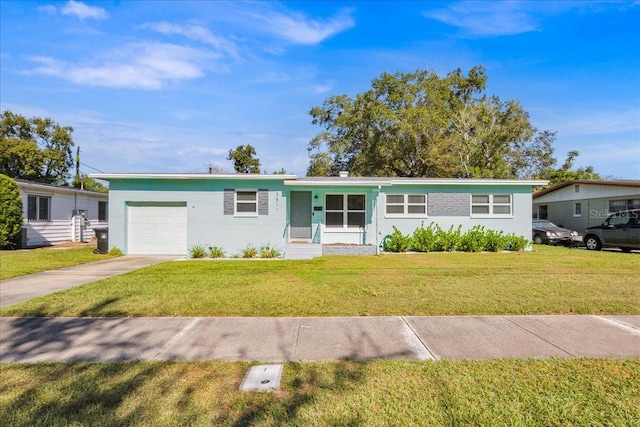 ranch-style house with a garage and a front lawn