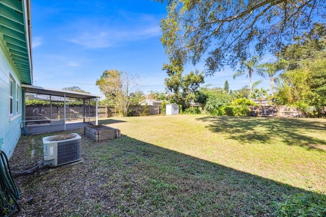 view of yard with central AC and a storage shed