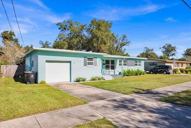 single story home featuring a garage and a front yard