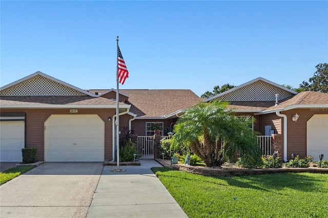 view of front of home featuring a front yard and a garage