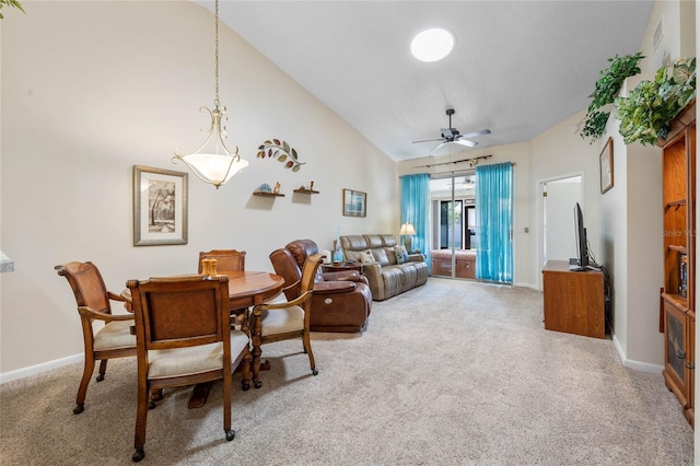 dining space featuring high vaulted ceiling, carpet flooring, and ceiling fan