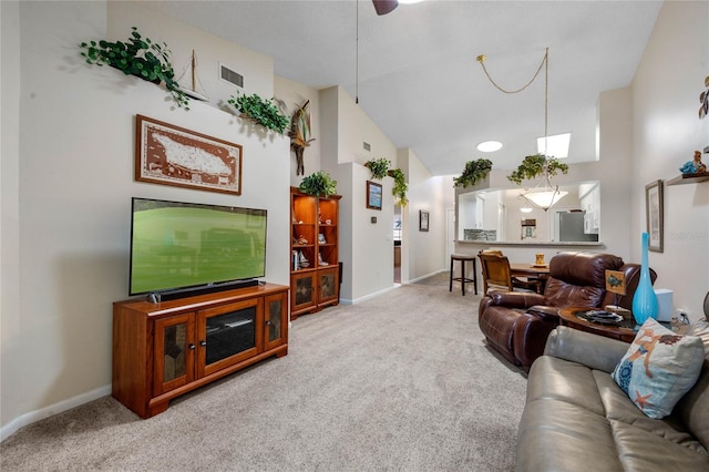 carpeted living room featuring high vaulted ceiling