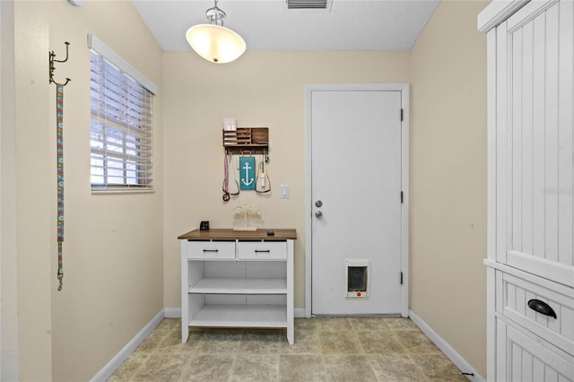 interior space with a textured ceiling