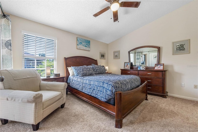 bedroom featuring light carpet, ceiling fan, lofted ceiling, and a textured ceiling