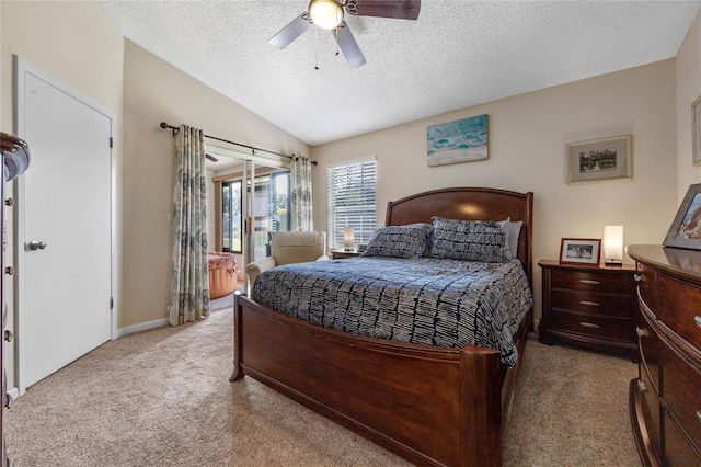 bedroom featuring lofted ceiling, ceiling fan, light carpet, and a textured ceiling