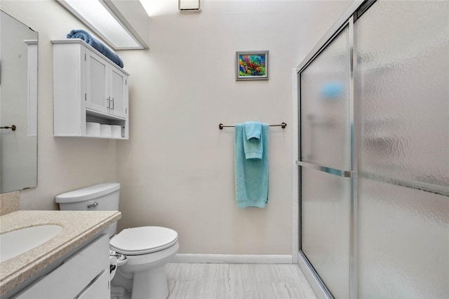 bathroom with an enclosed shower, vanity, and toilet