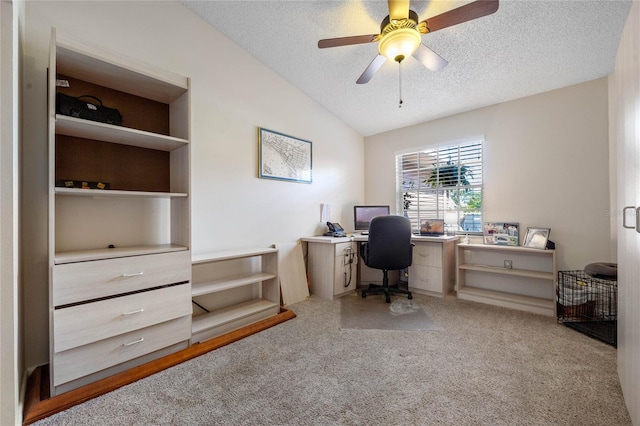 carpeted home office with lofted ceiling, ceiling fan, and a textured ceiling