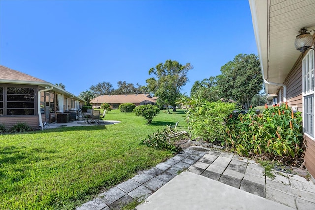 view of yard featuring a patio area and central AC