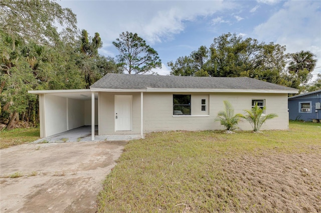 ranch-style house with a front yard and a carport