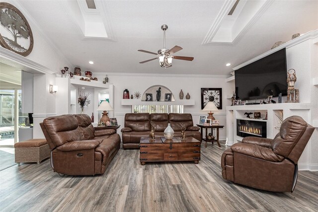 living room featuring crown molding, hardwood / wood-style floors, and ceiling fan